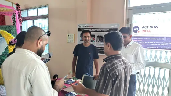 Men talking at the Act Now India display.